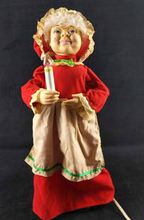 Animated Christmas Mrs Claus Display With Candle: Mrs Claus holds a candle to push away the night. When plugged in, she pulls the candle closer to her face. Figure is approx 6 1/2" x6 1/2" x 24". Is in good, used condition with a dusty apron and a