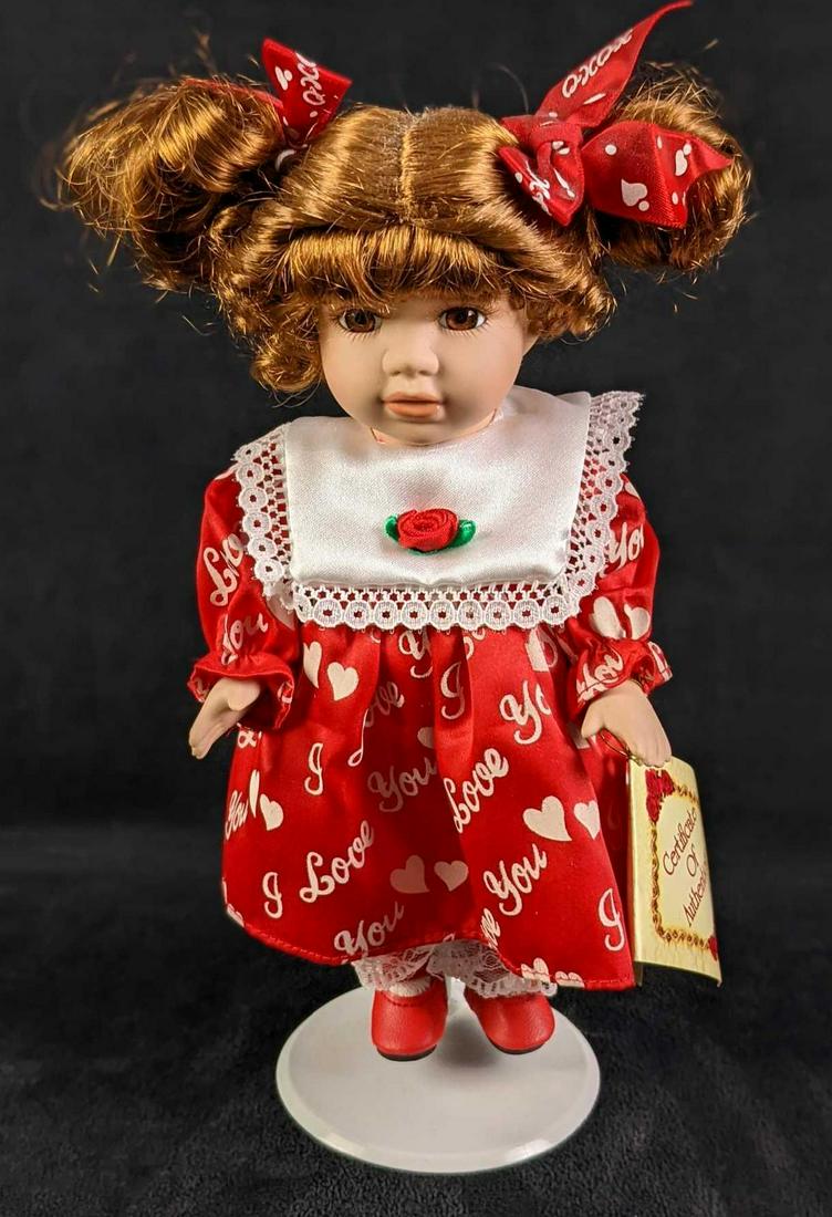 Collectors Choice I Love You Porcelain Girl Doll: Collectors Choice I Love You Porcelain Girl Doll. Head, arms, hands, legs and feet are made of porcelain. Body is plush. Collectors Choice" printed on back of doll's neck. Dress has "I Love You" and h