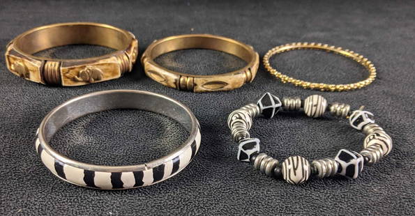 Safari Themed Bangles Zebra Elephant Bangles: Safari Themed Bangles Zebra Elephant Bangles This is a set of safari-themed bangles. They can be stacked and worn together. There are zebra bracelets and earth tones elephant bracelets with a gold