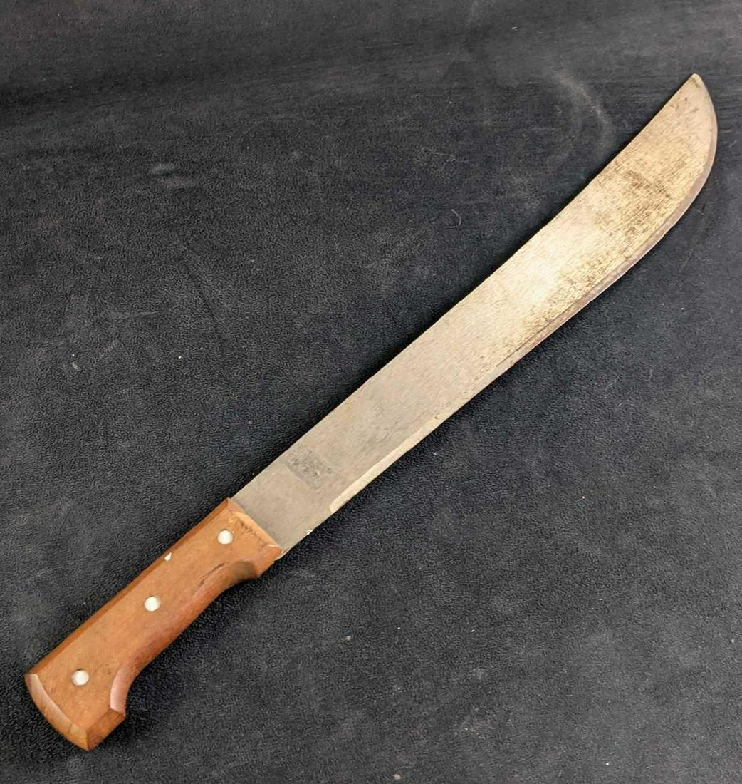 Tramontina 18" Machete with Hardwood Handle: Tramontina 18" Machete with Hardwood Handle This Machete is from Brazil by the brand Tramontina. It has a nice hard wood sturdy handle. This machete is in good condition with the exception of some sur