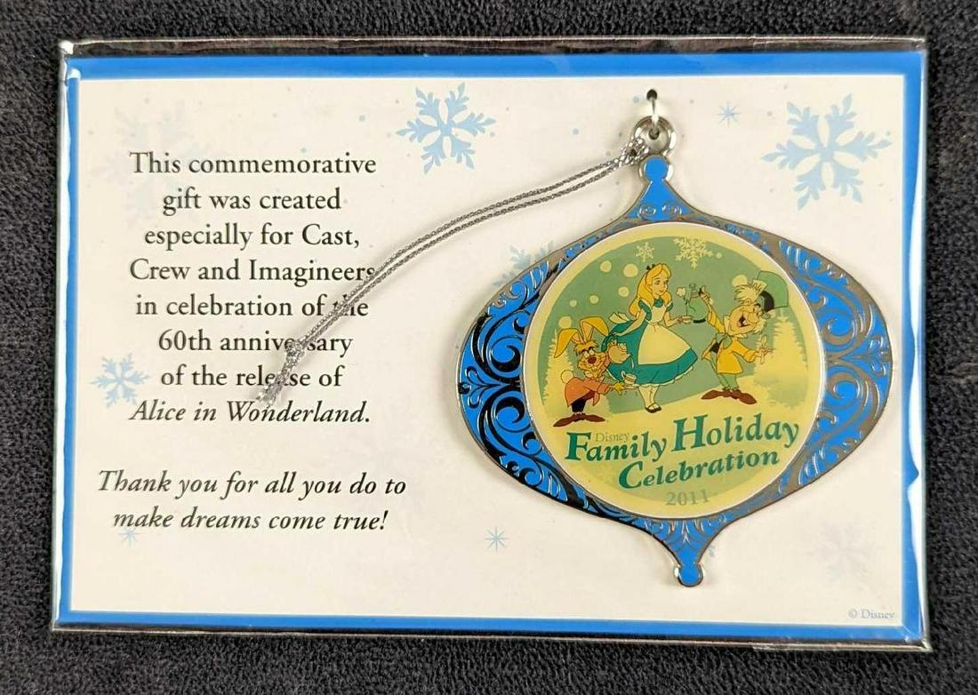 Alice In Wonderland Disney Christmas Ornament: This commemorative silver-tone metal gift ornament was created especially for Cast Crew and "Imagineers" in celebration of the 60th anniversary of the release of Alice in Wonderland. In great conditio