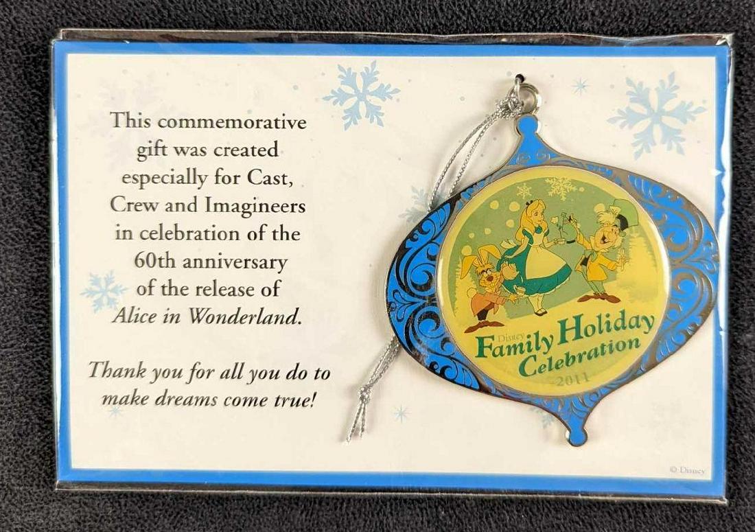 Alice In Wonderland Disney Christmas Ornament: This commemorative silver-tone metal gift ornament was created especially for Cast Crew and "Imagineers" in celebration of the 60th anniversary of the release of Alice in Wonderland. In great conditio