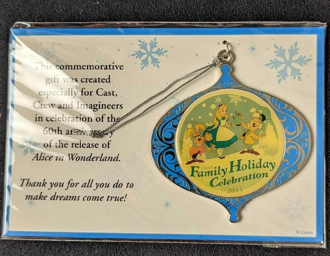 Alice In Wonderland Disney Christmas Ornament: This commemorative silver-tone metal gift ornament was created especially for Cast Crew and "Imagineers" in celebration of the 60th anniversary of the release of Alice in Wonderland. In great conditio