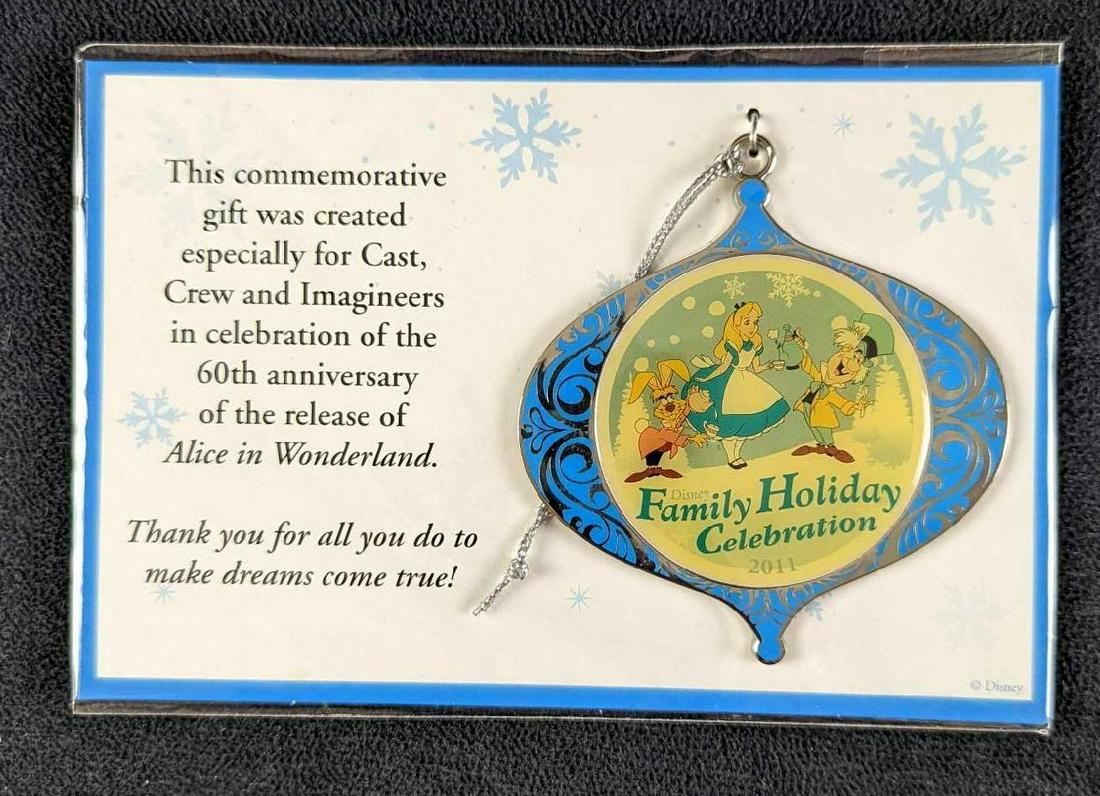 Alice In Wonderland Disney Christmas Ornament: This commemorative silver-tone metal gift ornament was created especially for Cast Crew and "Imagineers" in celebration of the 60th anniversary of the release of Alice in Wonderland. In great conditio