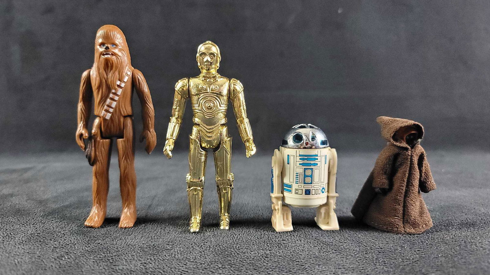 1977 Star Wars Action Figure Lot of 4: 1977 GMFGI Star Wars action figures, lot contains: 1- R2-D2 1- C-3PO 1- Chewbacca 1- Jawa They are in good used vintage condition. Chewbacca is missing his firearm. No other damages known. Weight of a