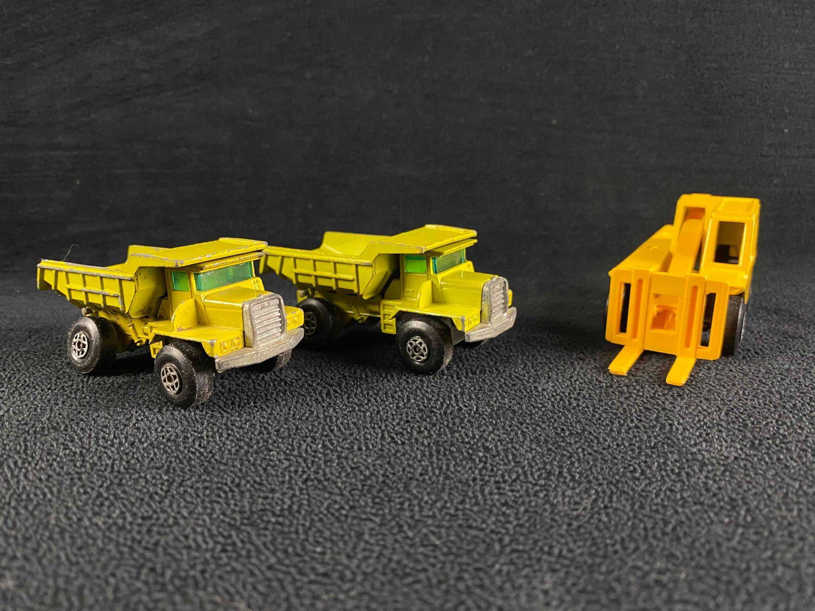 3 Vintage Matchbox: Dumptrucks & Jacklift: 3 Vintage Matchbox: Dumptrucks & Jacklift Lot of 3 vintage Matchbox vehicles: two green dumptrucks and one yellow jacklift. All are in good condition with no known damage, though the dumptrucks have s