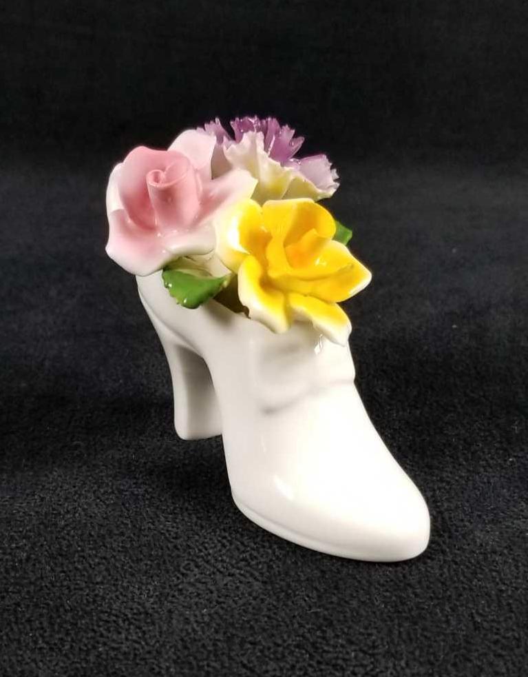 Radnor Like Bone China Minature Flowers in Heel: This bone china, miniature shoe was made in England. Maker is unknown but it is a Radnor like design. Dainty heel holds capodimonte style flowers. It is in good vintage condition.There are no known da