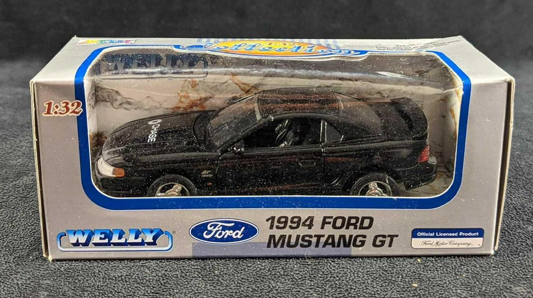 Welly 1994 Ford Mustang GT 1:32 Scale Die Cast Car: Welly 1994 Ford Mustang GT 1:32 Scale Die Cast Car. This one is branded "Chase" on the hood, The die-cast car is approx 6 3/4" x 2 1/2" x 2 3/4" and it weighs 0.47lb. The car has never been removed fr