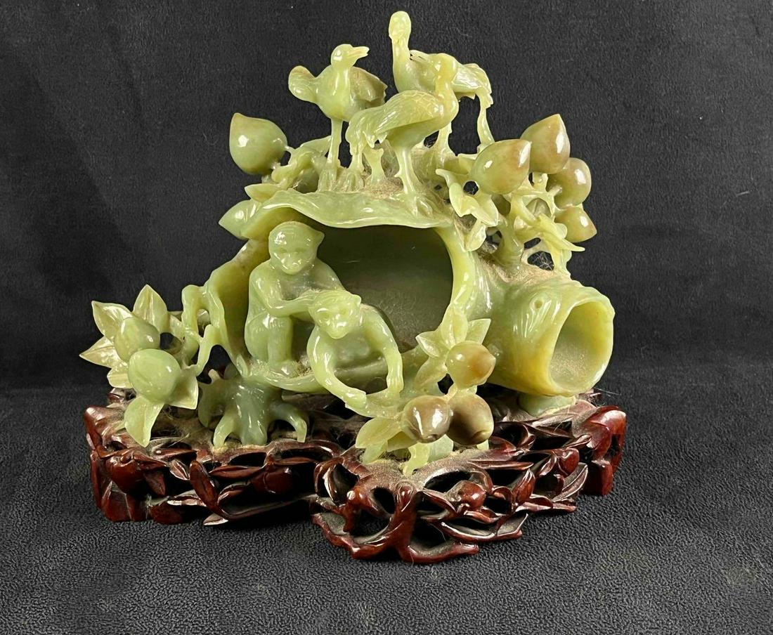 Carved Jadeite Tree Sculpture on Wood Carved Base: Carved Jadeite Tree Sculpture on Wood Carved Base Pictured is a vintage carved jadeite tree sculpture with birds and monkeys. This sculpture is on a wood-carved base. This piece is in good condition w