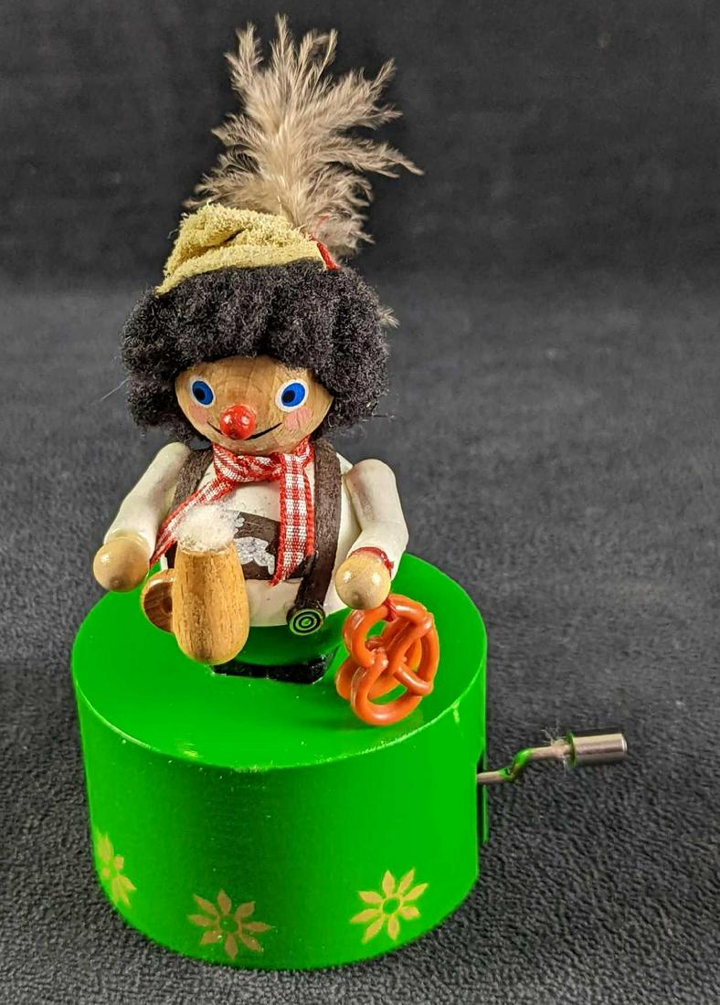 Steinbach GMBH German Musical Bavarian: Handmade in Germany, this one of a kind toy features a wooden German boy holding a pretzel and what appears to be a root beer. The music box is approx 3 3/8" x 3" x 5 1/4". The music box plays "Edelwe
