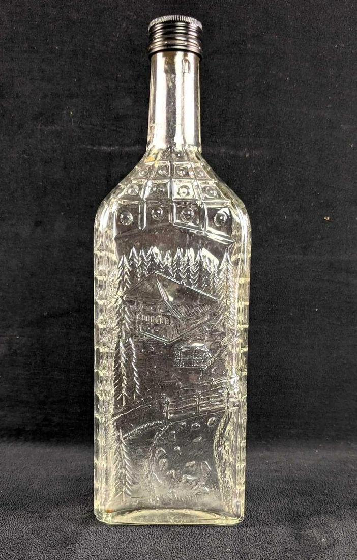 Vintage Glass Bottle With Design Germany: Vintage Glass Bottle With Design Germany This glass bottle has a beautiful cabin in the woods. The bottle is emptied and in good condition with no known damage. The bottom says "Germany". The design i