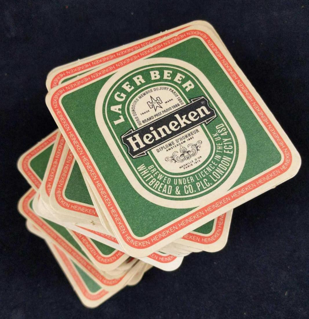Rare Lot Of Square Heineken Beer Coasters: Here is a rare lot of square Heineken beer coasters. There are around 40 plus coasters in this lot. Coasters show Heineken's logo in green along with a border that just says Heineken over and over aga