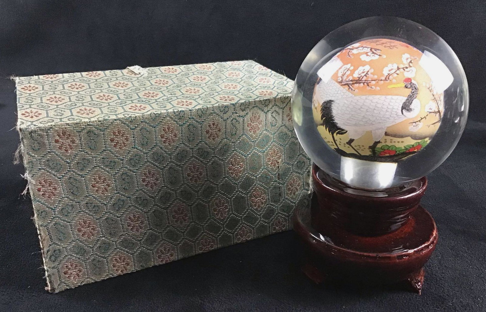 Hand painted Blown Glass Art with Chinese Red Crowned Cranes on Revolving Wooden Pedestal Modern B: This is blown glass that is hollowed out to be painted on the inside. Artists use specialty brushes and magnifying glasses to paint the details inside the glass globe. The wooden pedestal revolves man