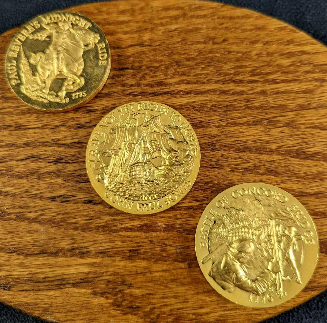 3 Longines Symphonette 24K Gold Over Bronze Medallions: This lot includes thee Longines Symphonette 24K Gold Over Bronze Medallions. Each is approx 1 1/2" x 1 1/2" and together they weigh 0.21lb. This includes: (1) "Battle Of Concord Bridge". One side show