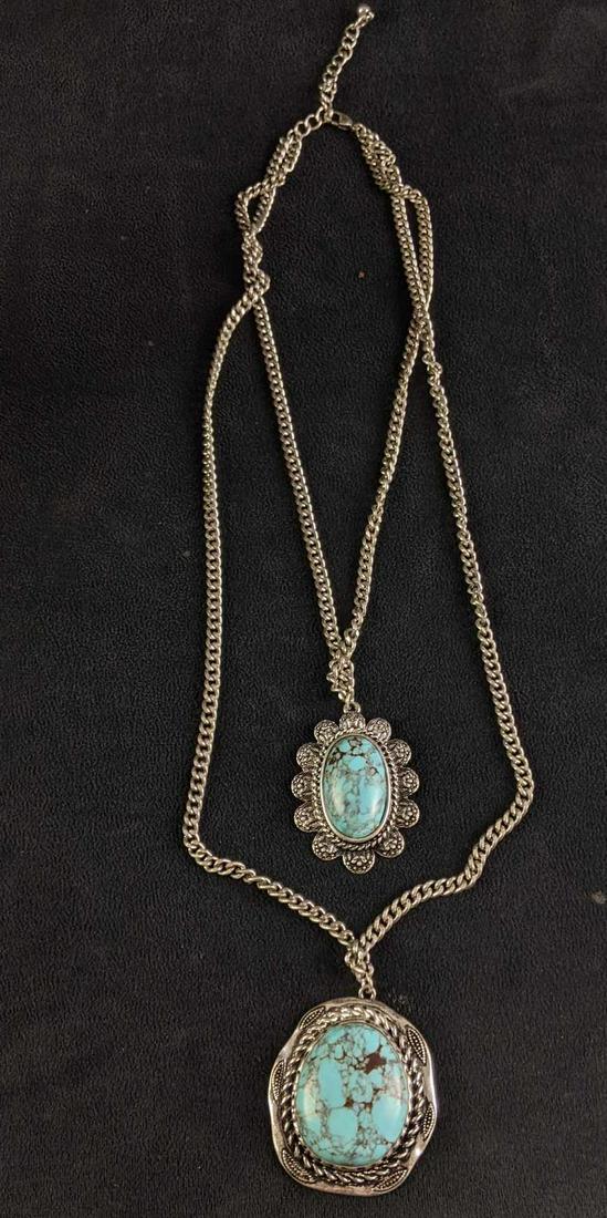 Turquoise Style Silver Necklace: Turquoise Style Silver Necklace This necklace has synthetic turquoise and silver-colored chain/ settings. This is one necklace that consists of two chains and charms. This is a beautiful accessory to