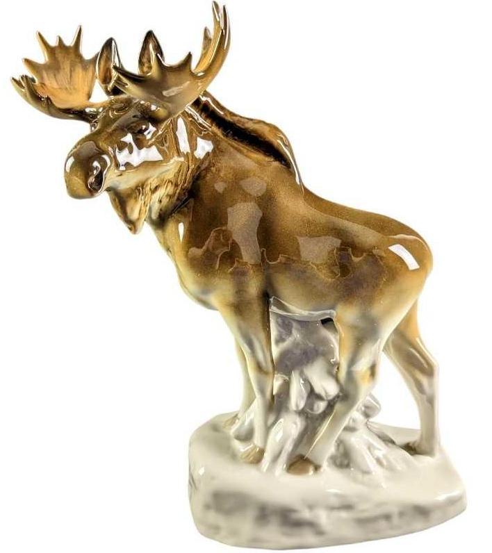 JB Moose Lomonosov Porcelain Collectible Figurine: Hand-painted porcelain moose figurine. Made in Russia by the Imperial Lomonosov Porcelain Factory. Is approx 10" x 4 1/2" x 13 1/2" and it weighs 3.95lbs. The figurine is in a good, vintage condition 