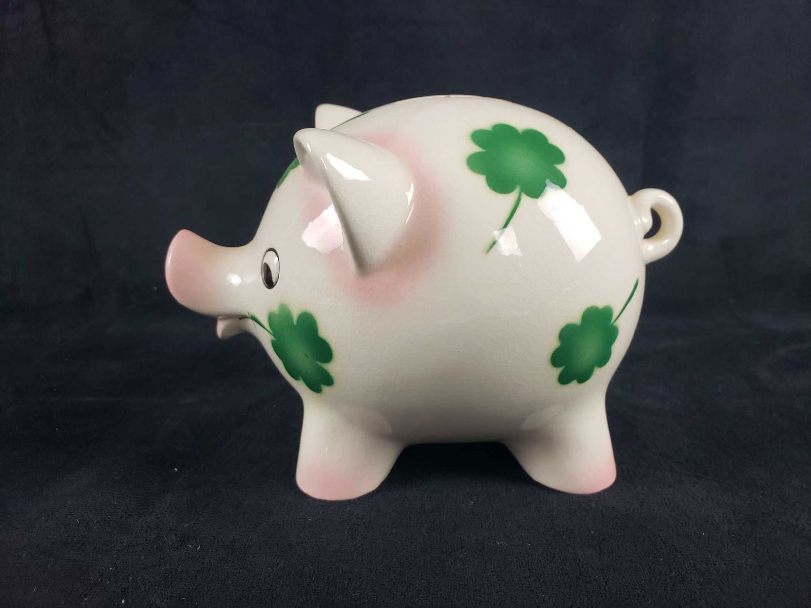 Goebel Shamrock Piggy Bank: Goebel Shamrock Piggy Bank. This piggy bank is in good used condition. There are some minor chips around the coin insert area. The bank is also missing the key. The piggy bank has a shamrock design. P