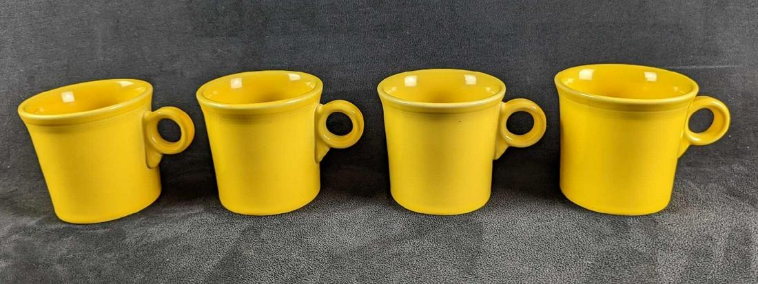 4 Vintage Yellow Sunflower HLC Fiesta Mugs: 4 Vintage Yellow Sunflower HLC Fiesta Mugs. Each is approx 5" x 2 1/2" x 3 1/2" and together they weigh 3.64lbs. The mugs are in a good, vintage condition with some signs of wear and scratches.