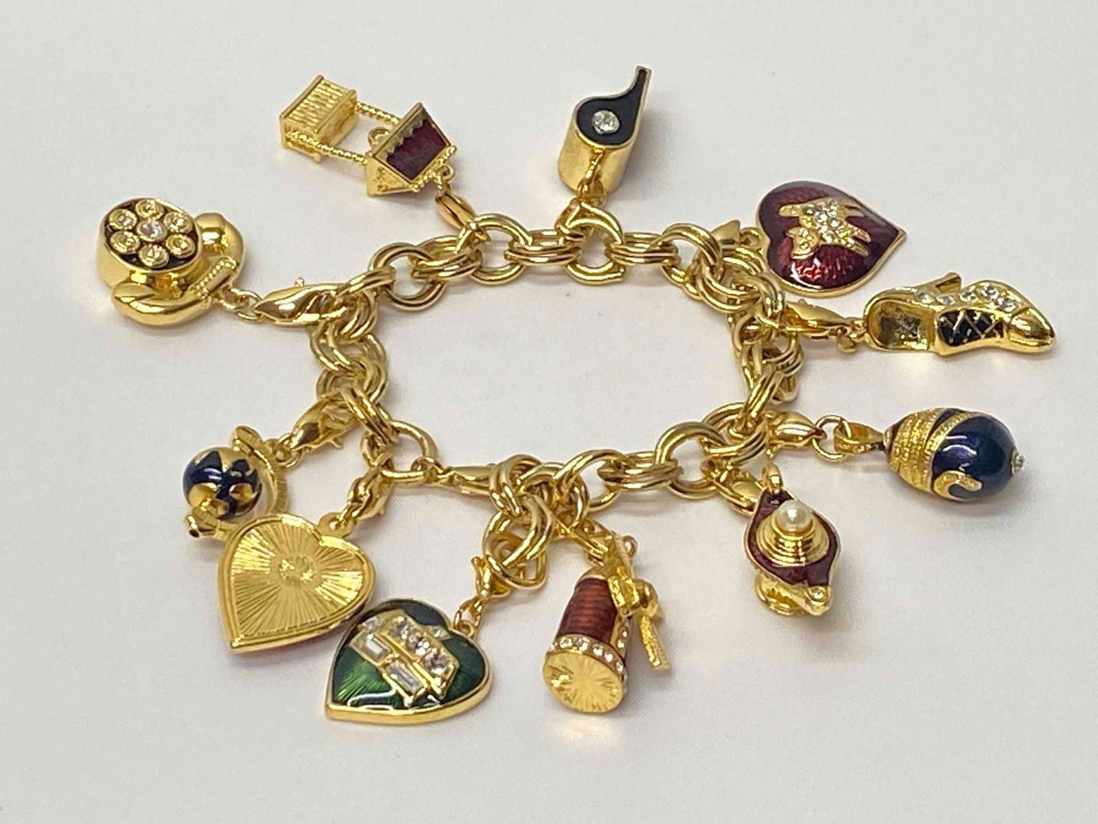 Gold Plated Enamel W/ 11 Charms Bracelet: Gold Plated Enamel W/ 11 Charms Bracelet This costume Jewelry has been tested and researched prior to listing. Please view all our pictures prior to bidding,they are part of the description. Metal - G