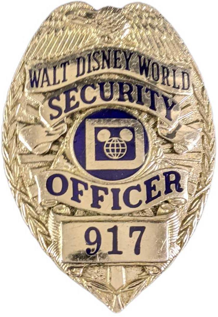 Early 1980s Disney World Security Metal Badge: Early 1980s Disney World Security Metal Badge. Is approx 2 1/4" x 3/4" x 3" and it weighs under one pound at 0.15lb. The metal badge is in a good, vintage condition with some wear and mini scratches a