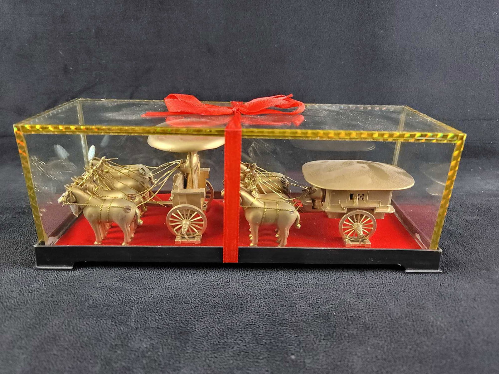 Qinling Warrior Carriage Chariot Asian Relics: Qinling gold tone warrior carriage/chariot. In glass case. This replica piece resembles the design of several pieces usually cast in bronze. The front one is called Gaoche, and the back one is called 