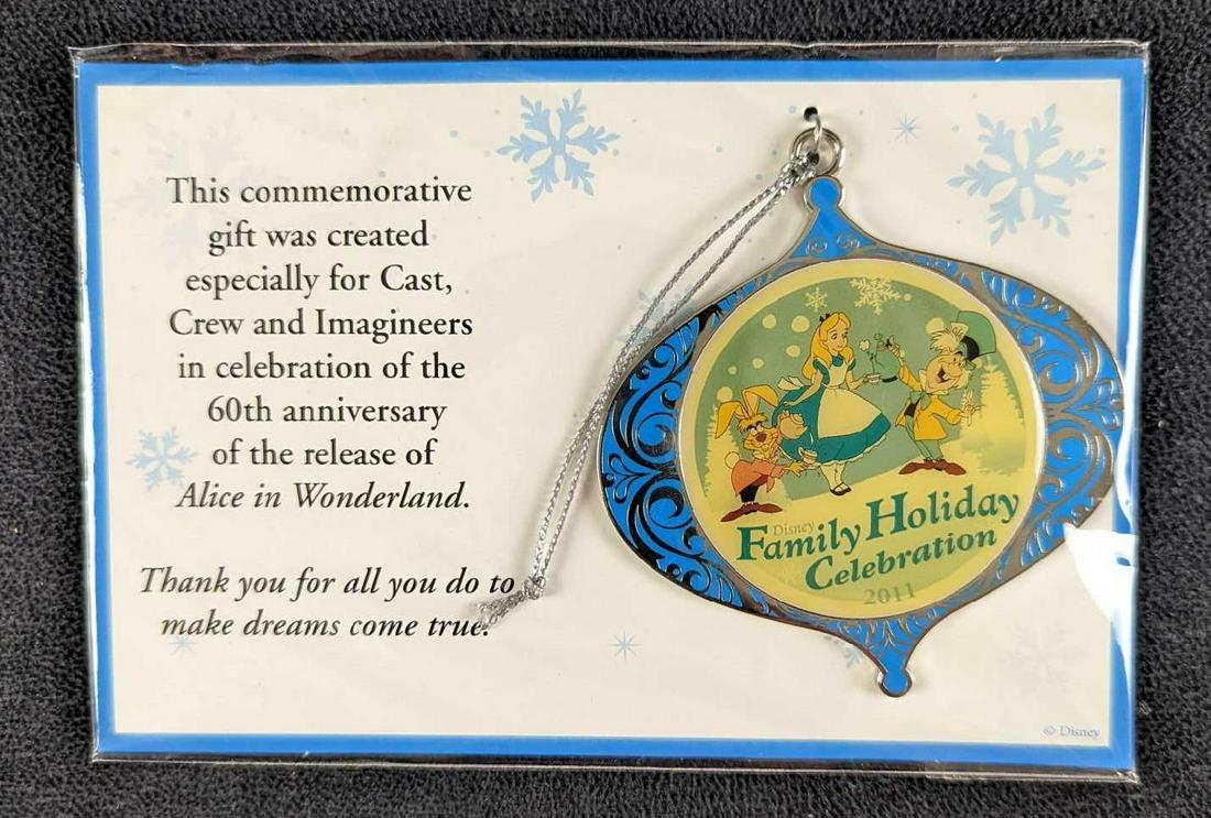 Alice In Wonderland Disney Christmas Ornament: This commemorative silver-tone metal gift ornament was created especially for Cast Crew and "Imagineers" in celebration of the 60th anniversary of the release of Alice in Wonderland. In great conditio
