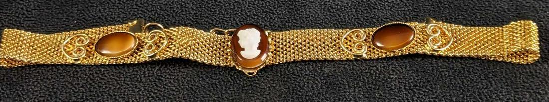 Choker Necklace Gold Colored: Choker Necklace Gold Colored The beautiful necklace has faux tiger's eye with a white lady silhouette. It is in good condition lightly used, The clasp works and is good. This necklace is a great piece