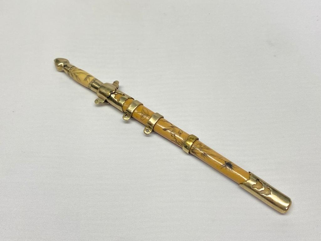 Vintage Carved Bone Sword Letter Opener: Vintage Carved Bone Sword Letter Opener Vintage letter opener, shaped like a sword with designs carved into the bone sheath and handle. Maker is unknown, but the blade is stamped with two crossed hamm
