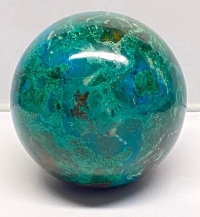 3" Chrysocolla Sphere: 3" Chrysocolla Sphere Chrysocolla sphere, smoothly polished. Comes with a small rubber circle to sit on. Interesting colors and veins make this a mesmerizing display item. The sphere includes several