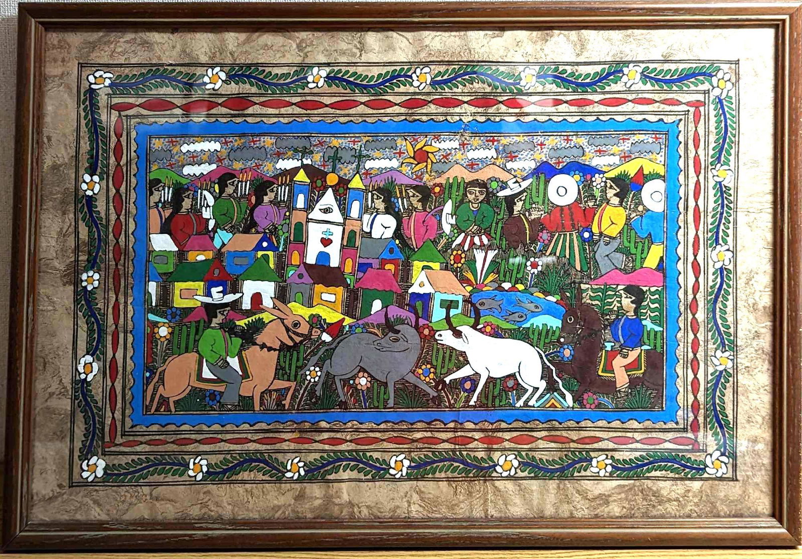 Framed Mexican Amate Bark Painting Folk Art: Framed Mexican Amate Bark Painting Folk Art. The framed painting shows a colorful village with its homes, people, and animals. This was not signed by the artist. The framed original is approx 24 1/2"