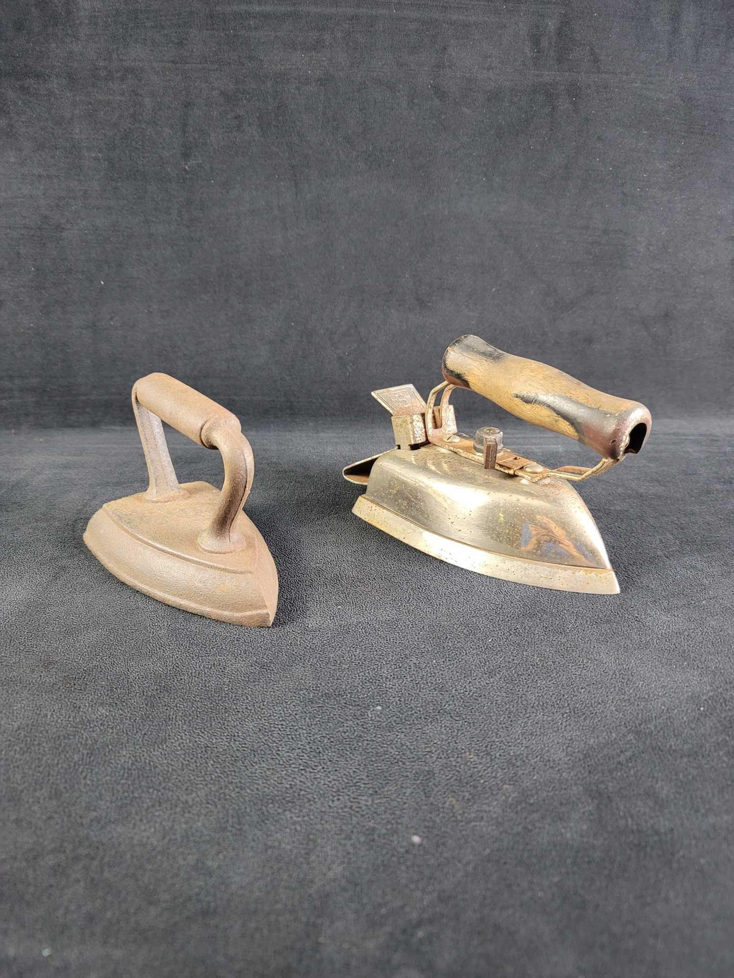 Antique Vintage Cast Iron Sunbeam Irons: This lot contains: 1- Sunbeam Master Automatic Electric Clothes Iron. Has wooden handle but missing cord and is rusted in areas. Approx. measures 4 1/2" x 5" x 8" weight 6.3 lbs 1- Unbranded Cast Iron