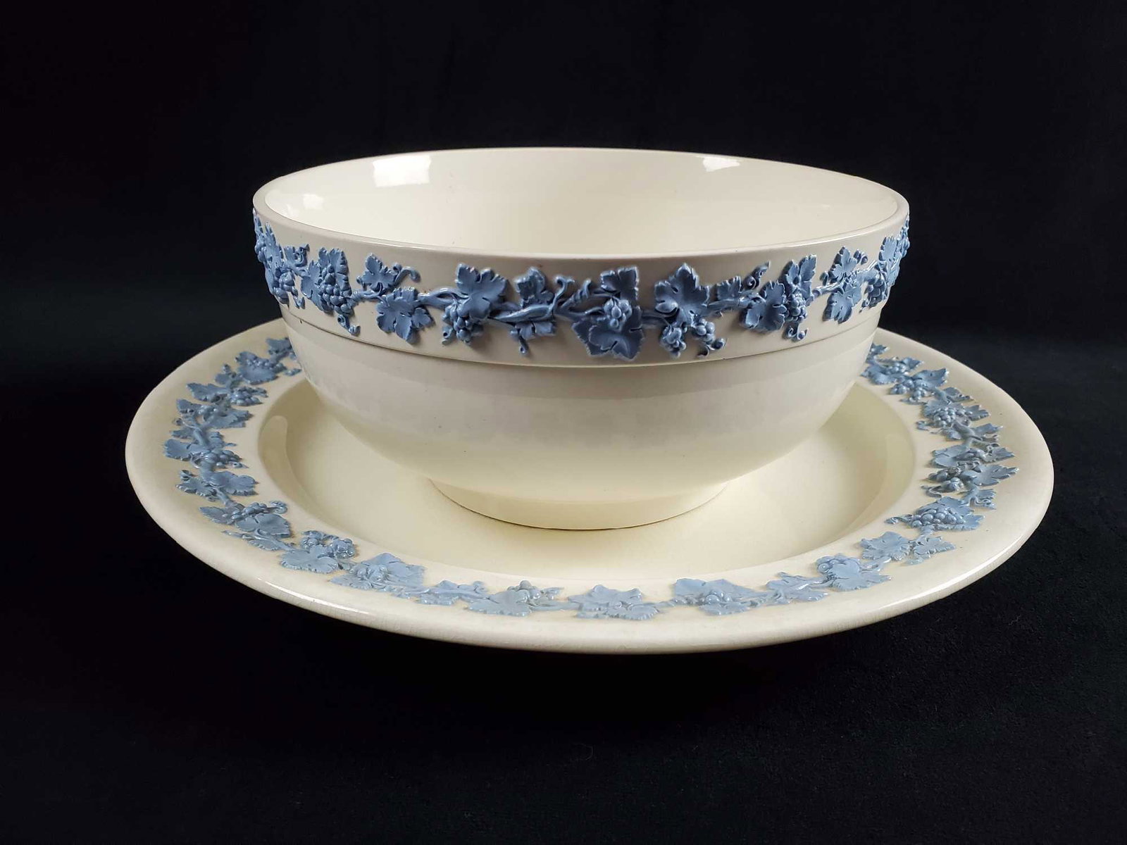 Wedgwood QueensWare Blue On Cream Bowl And Platter: This lot includes retired Fine China by Wedgewood. Both have a blue textured grapevine on cream design. Series was sold 1930 - 1988. (1)Wedgewood Queens Ware Blue On Cream Serving Bowl. Bowl is approx