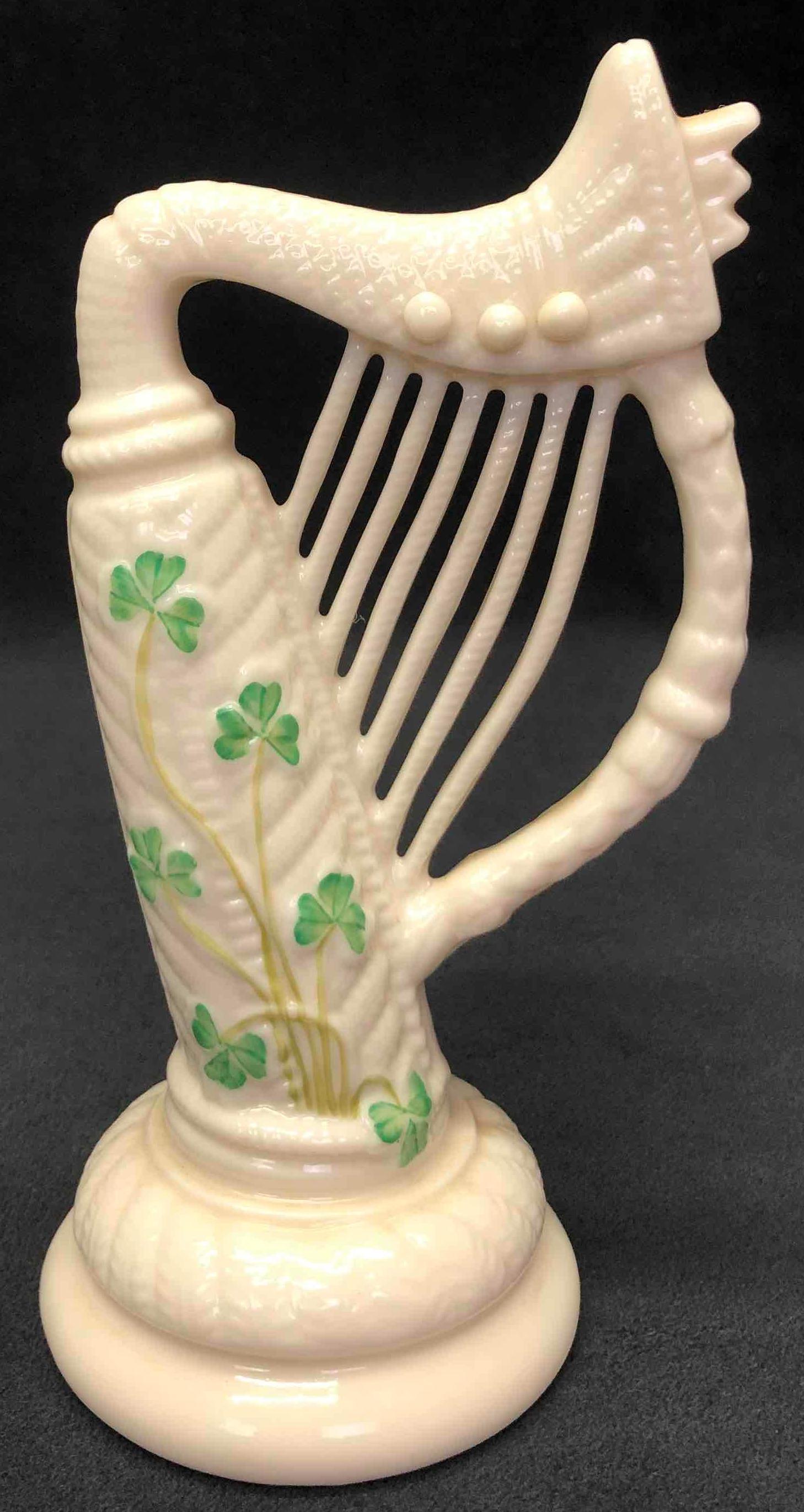 Irish China Pottery Harp Sculpture By Belleek Accents: This lot contains an Irish China Pottery Harp Sculpture by Belleek Accents. The bottom of the figurine is stamped with the Belleek Accents logo. It is approx 3" x 2 1/2" x 6" and weighs about 0.3lbs. 
