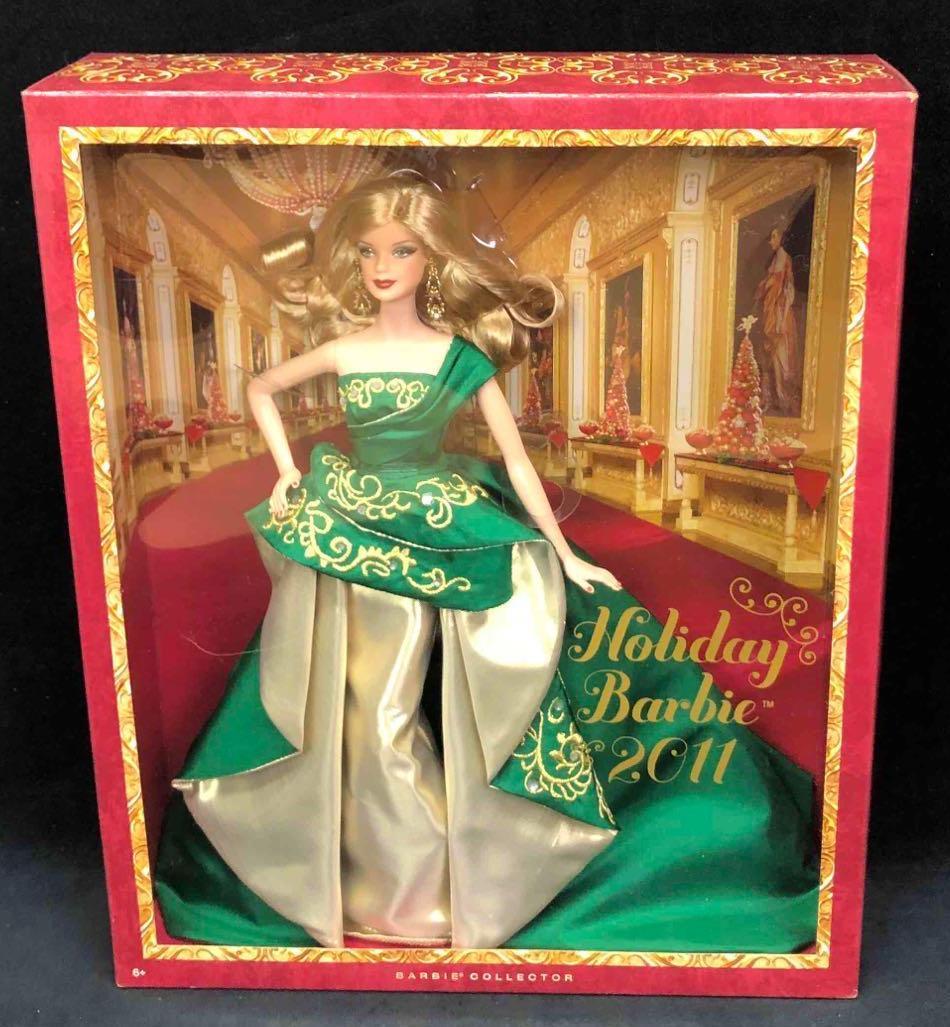 2011 Holiday Barbie: This lot contains a 2011 holiday Barbie from the Barbie Collector. This Barbie comes in her original packaging and has never been opened. Accessories include her earrings, shoes and dress. The box is