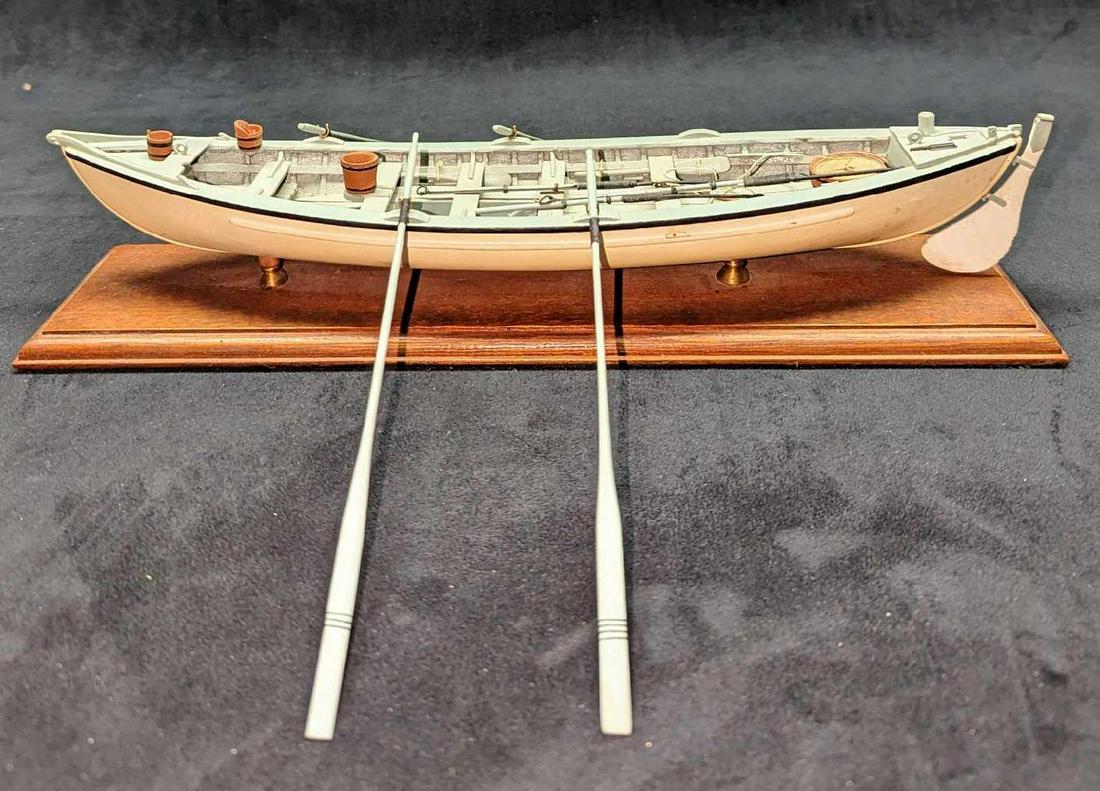 Vintage Wood Whale Boat Model: Vintage Wood Whale Boat Model. Maker and date of creation are unknown. This is approx 15" x 4" x 3" and it weighs 1.25 lbs. The ship has some markings and one of the paddle holders is missing. Comes w