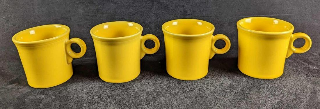 4 Vintage Yellow Sunflower HLC Fiesta Mugs: 4 Vintage Yellow Sunflower HLC Fiesta Mugs. Each is approx 5" x 2 1/2" x 3 1/2" and together they weigh 3.61lbs. The mugs are in a good, vintage condition with some signs of wear and scratches.