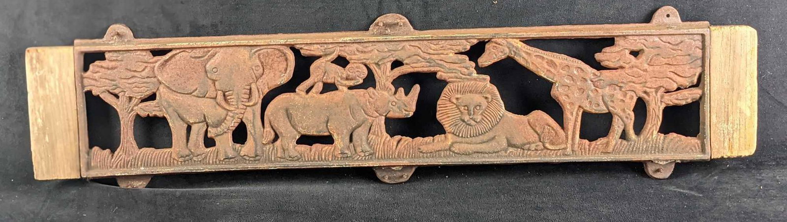 Cast Iron Panel With Savanna Animals Lion Elephant: This vintage panel shows an elephant, rhino, monkey, lion, and giraffe hanging out together by some trees. The panel is attached to some wood and is approx 32" x 3/4" x 8" and it weighs 9.5lbs. The pa