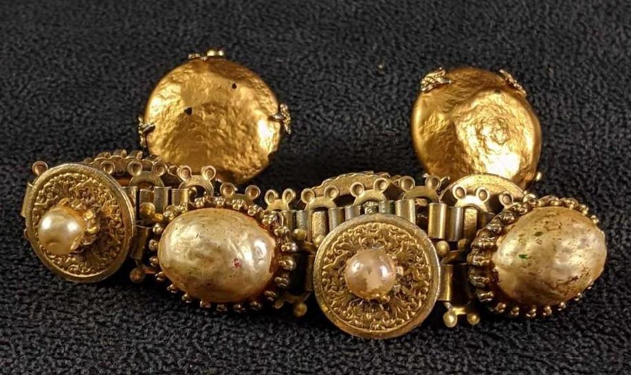 Bracelet and Clip-on Earring Set: Bracelet and Clip-on Earring Set. This set is gold-tone with a bracelet and earrings used the earrings have some black stops that are tiny chips. The total weight is 0.13lb.