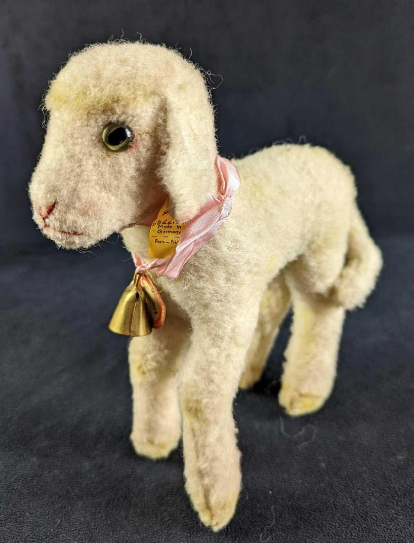 Vintage Steiff Wool & Cotton German Lamby Lamb: Vintage Steiff "Lamby" Lamb. Has the ribbon, price tag, and name tag. Is approx 8 1/2" x 3" x 8 1/2" and it weighs 0.29lb. The lamb is in a good, vintage condition with some signs of wear along with t