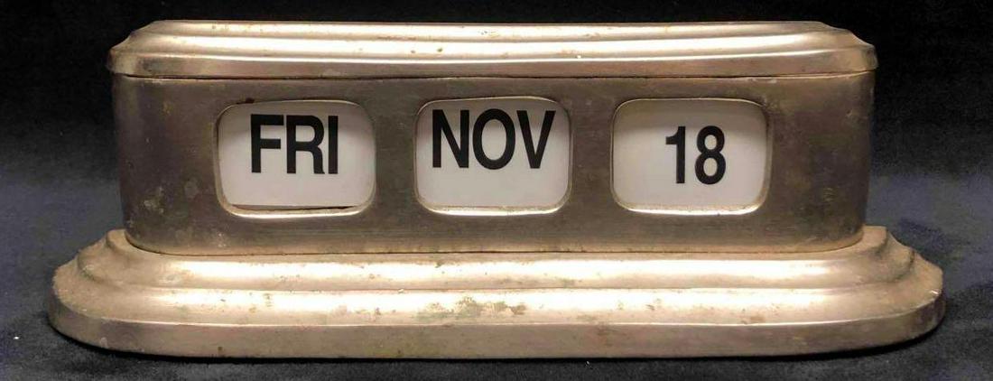 Vintage Metal Flip Table Calendar: This lot contains a vintage metal flip table calendar. This calendar is perfect for any office or work space. It is approx 11" x 1 3/4" x 3 1/2" and weighs about 2.5lbs. The calendar is in
