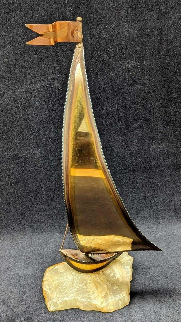 Brass Sailboat Figurine By DeMott: Brass Sailboat Figurine By DeMott. Hand-made brass and onyx sailboat. The artist's signature is on the bottom right of the sail. Is approx 5" x 4" x 15" and it weighs 1.60 lbs. The fig
