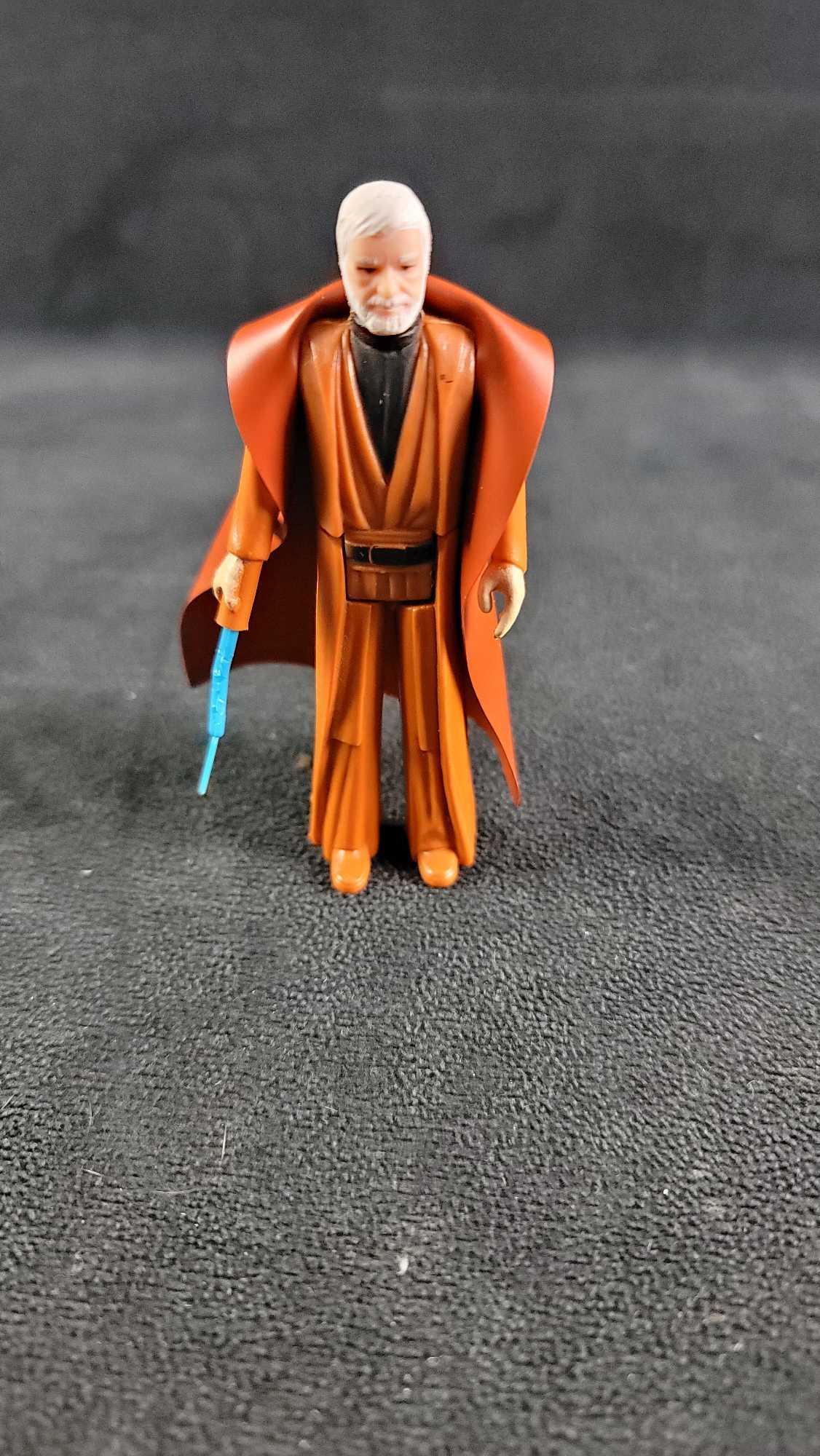 1977 Obi Wan Kenobi GMFGI Action Figure: 1977GMFGI Obi Wan Kenobi action figure, made in Hong Kong. In good vintage condition, with some damage to the light saber. Weight less than a pound and approx. measures 3 3/4"