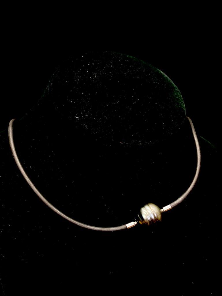 Tahitian Pearl on Rubber Necklace: Tahitian Pearl on Rubber Necklace Rubber necklace with Tahitian "black" pearl. The necklace clasps by pushing the ends to the holes drilled into the pearl and twisting until they lock into pl