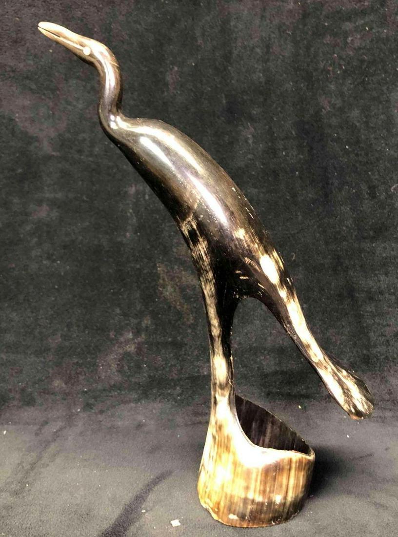 African Carved Horn Bird Sculpture: This lot contains an African carved horn bird sculpture. It is approx 6" x 2 3/4" x 9" and weighs about 0.2lbs. The sculpture is in good used condition with some light ware from use over t