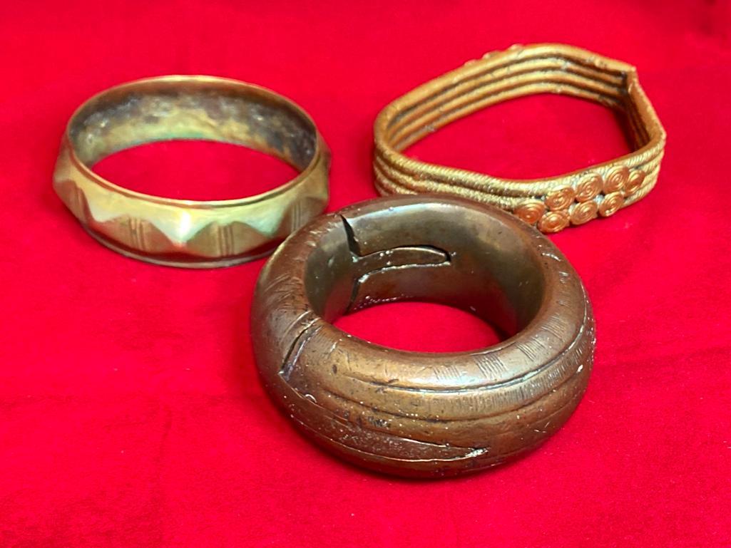 Lot of 3 African Brass Bangles: This piece of jewelry as been tested and researched prior to testing . Please view all our pictures they are part of our description. DETAILS: Metal - brass/bronze Color - gold/bronze Stones - None