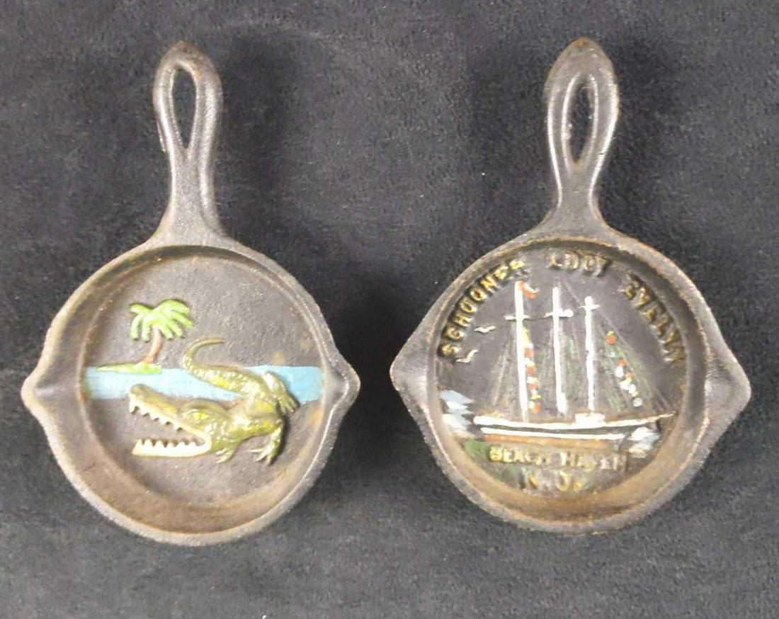 Vintage 2 John Wright Cast Iron Mini Frying Pans: Vintage John Wright Cast Iron Mini Frying Pan. From the 1940s and 1950s. This lot includes: (1) Schooner Lucy Evelyn At Beach, Haven New Jersey. (1) Menacing alligator near the ocean and palm tree.