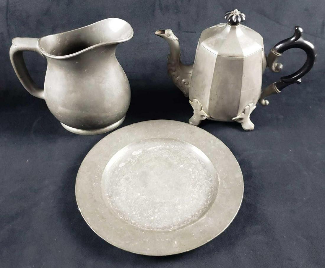Set of Pewter Plate Footed Teapot and Pitcher: Set of Pewter Plate Footed Teapot and Pitcher. This set contains: 1 pewter plate in fair condition. The plate has a good amount of scratches at the center and looks to have been used relatively freque
