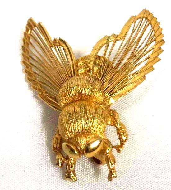 Cicada/Bee Brooch By Monet: This lot contains a Cicada/Bee brooch by Monet. The brooch is made of gold colored metal. This piece is very detailed in the unique outlined wings. It is approx 1 1/2" x 1 1/4" x 1/4" and weighs less