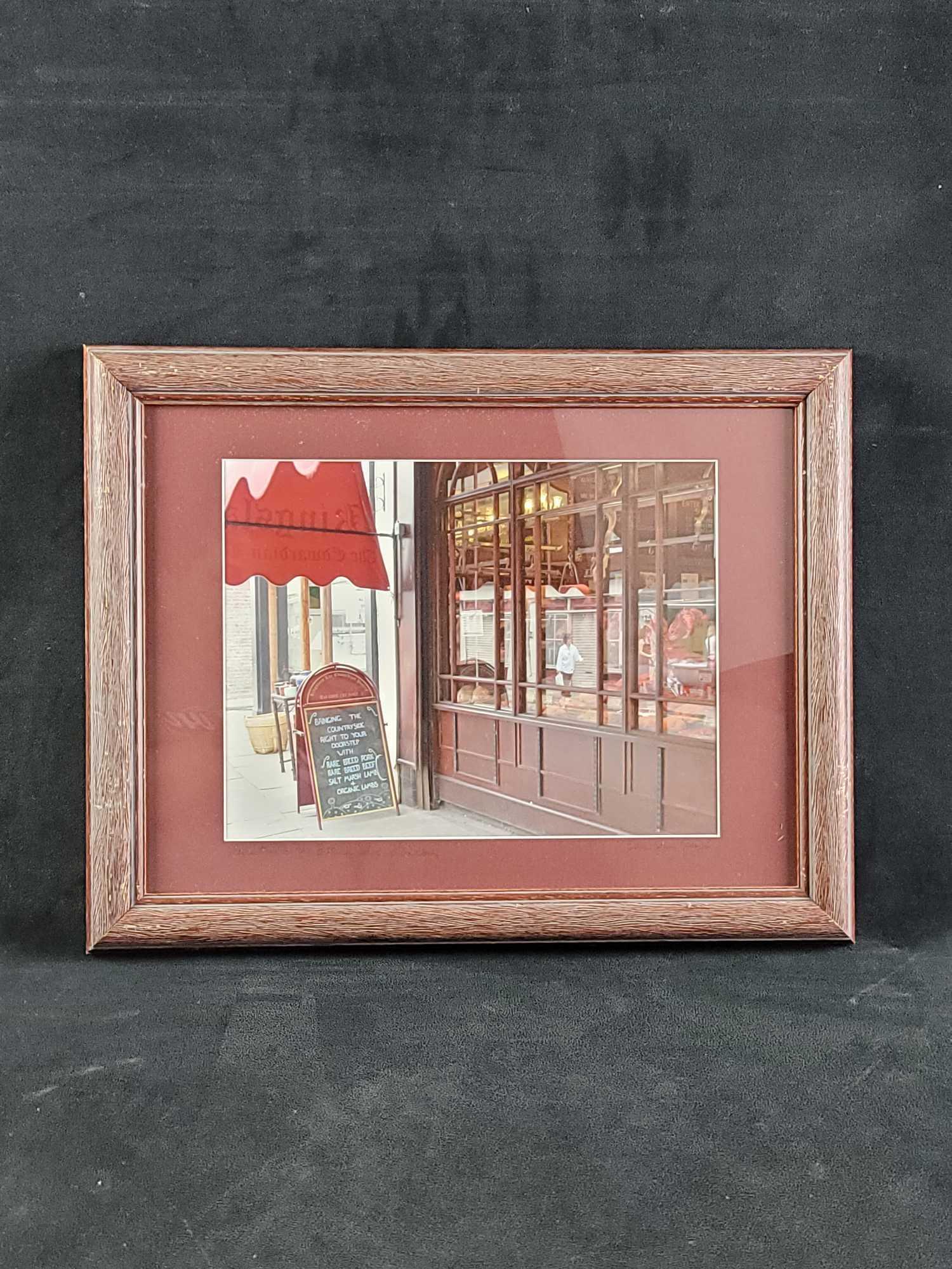 Reflection Photograph By Etta Jean Juge Outdoors London: The photograph is titled "Reflecting on the Butcher Shop" London. Artist is Etta Jean Juge. Framed, matted, and signed. In good condition, with some scuffs on the frame. Approx. measures 18" x 14 1/4"