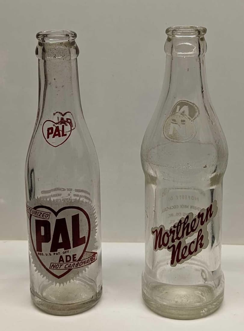 Vintage Pal Ade And Northern Neck Glass Bottles: Vintage Pal Ade And Northern Neck Glass Bottles. This lot includes: (1) Vintage Pal Ade Glass Bottle. This is approx 2 1/4" x 2" x 7 3/4". Has some residue inside the bottle. (1) Northern